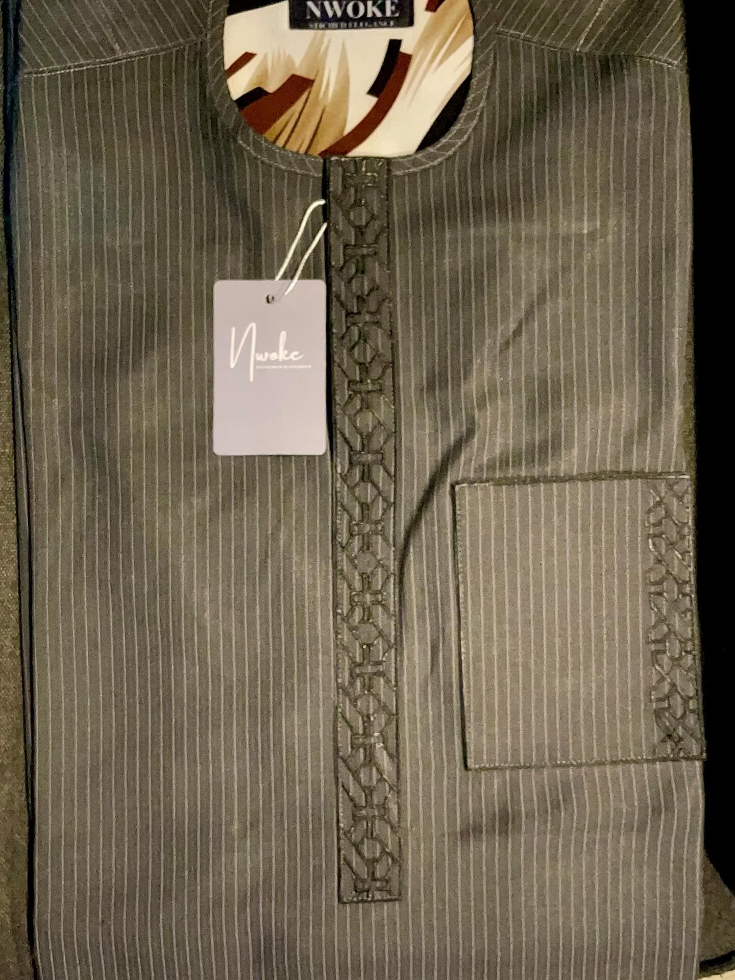 Close-up of an olive senator top with tonal embroidery running down the placket