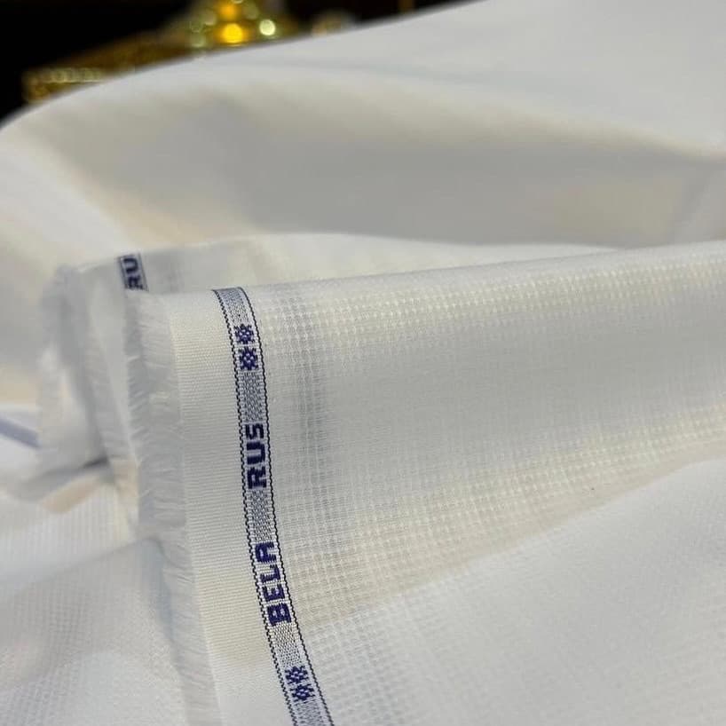Ivory fabric folded with a woven selvedge label